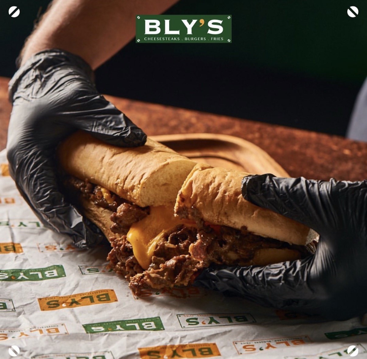 Cheese being poured over a Philly cheesesteak